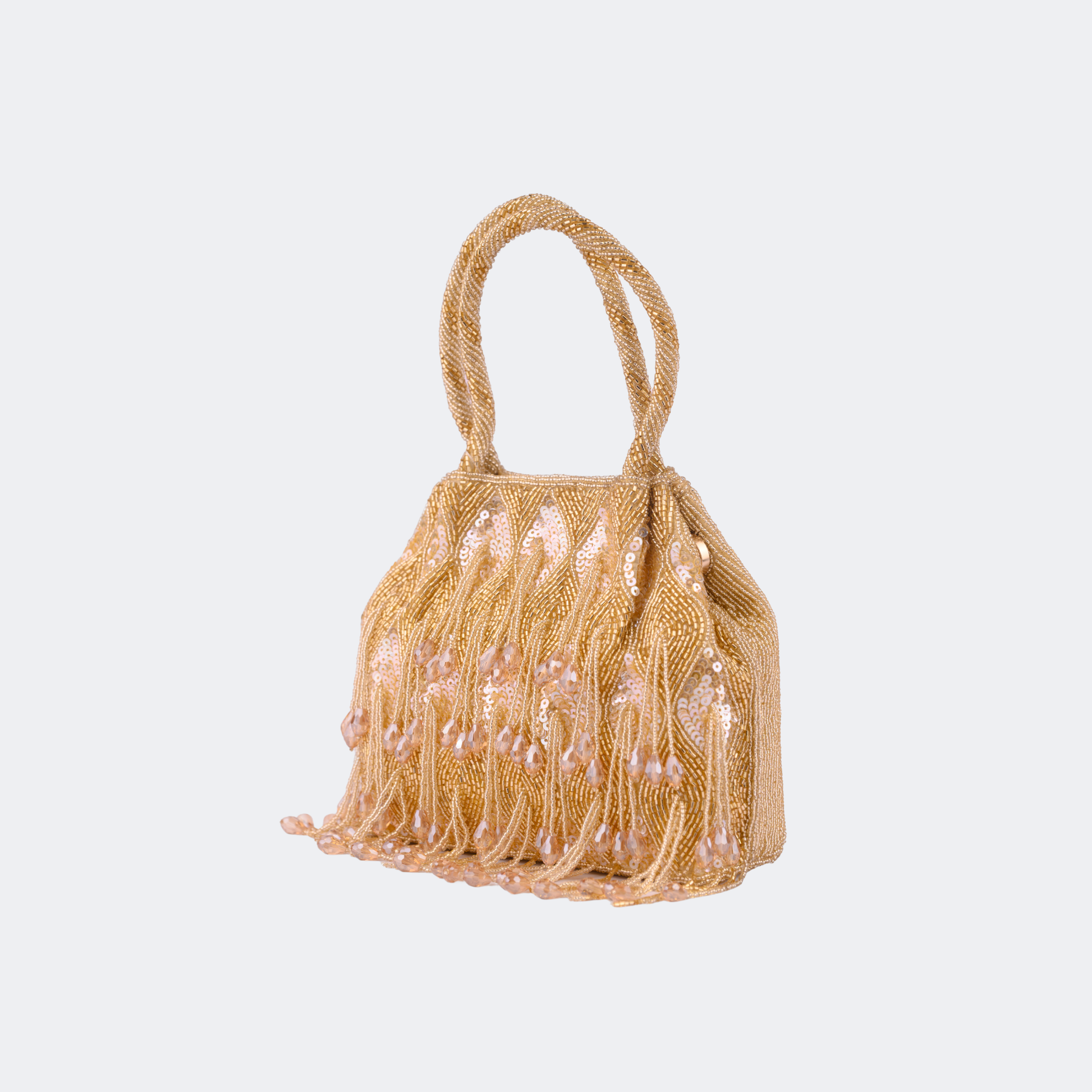 Beige handbag with pearl embellishments on a light gray background | Vogelle