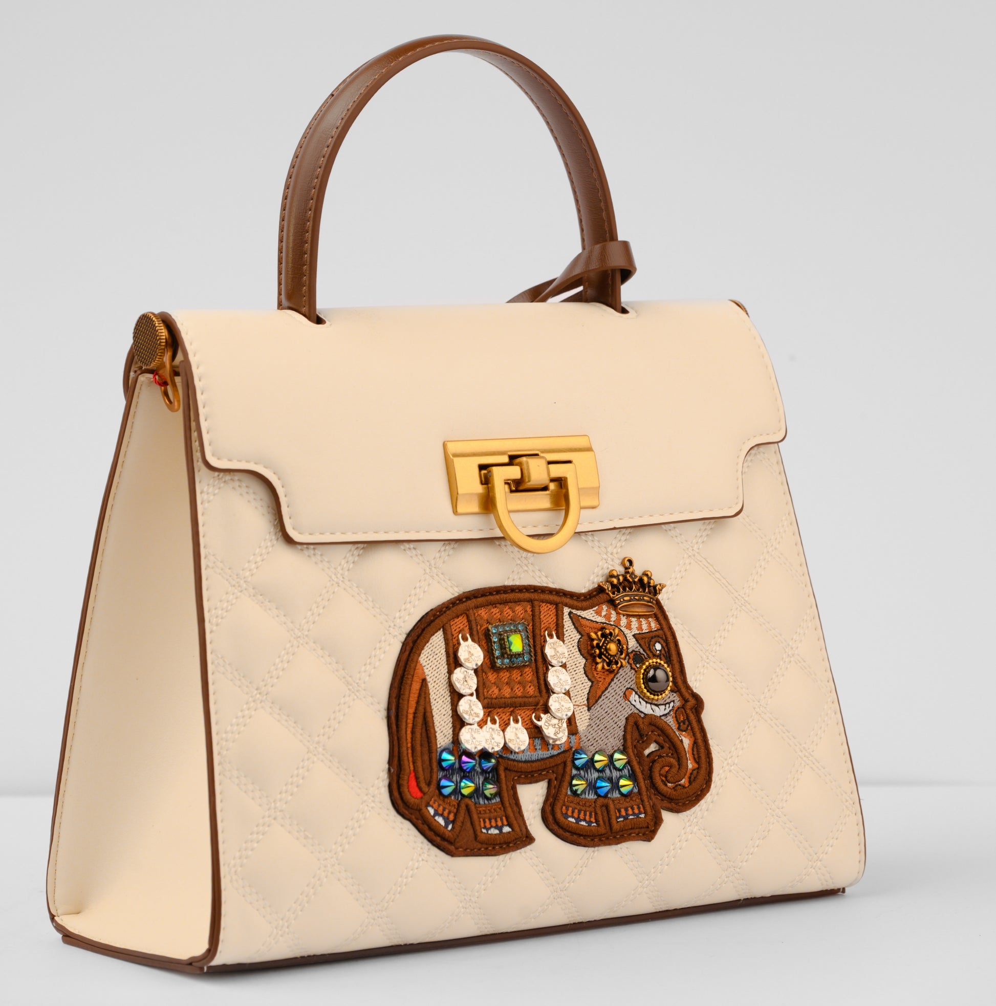 Beige handbag with a decorative elephant patch on a light gray background | Vogelle