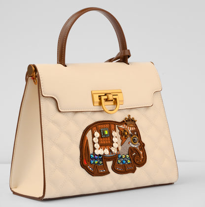 Beige handbag with a decorative elephant patch on a light gray background | Vogelle