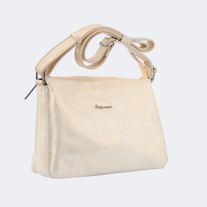 Beige handbag with decorative handle on a light gray background | Vogelle