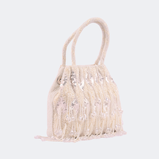 Beige handbag with fringe details on a light gray background | Vogelle