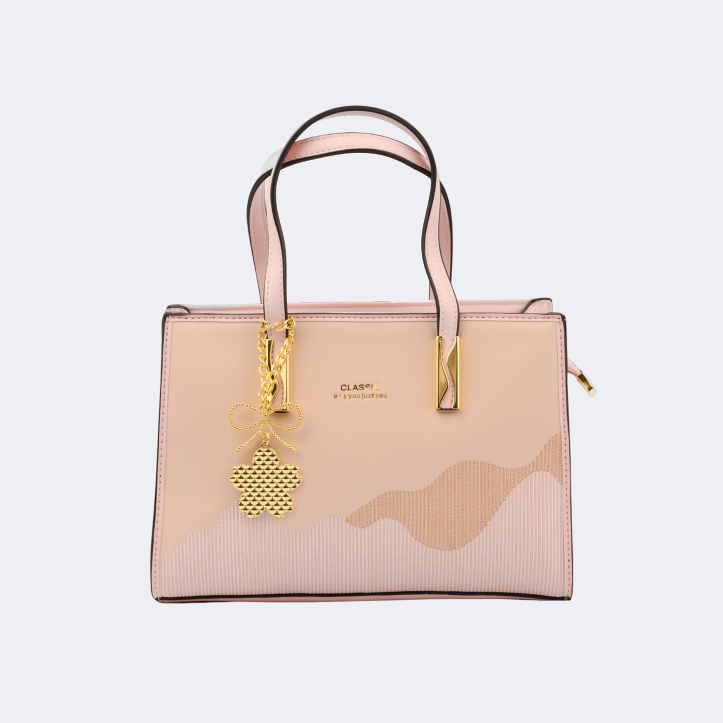 Beige handbag with gold accents on a light gray background | Vogelle