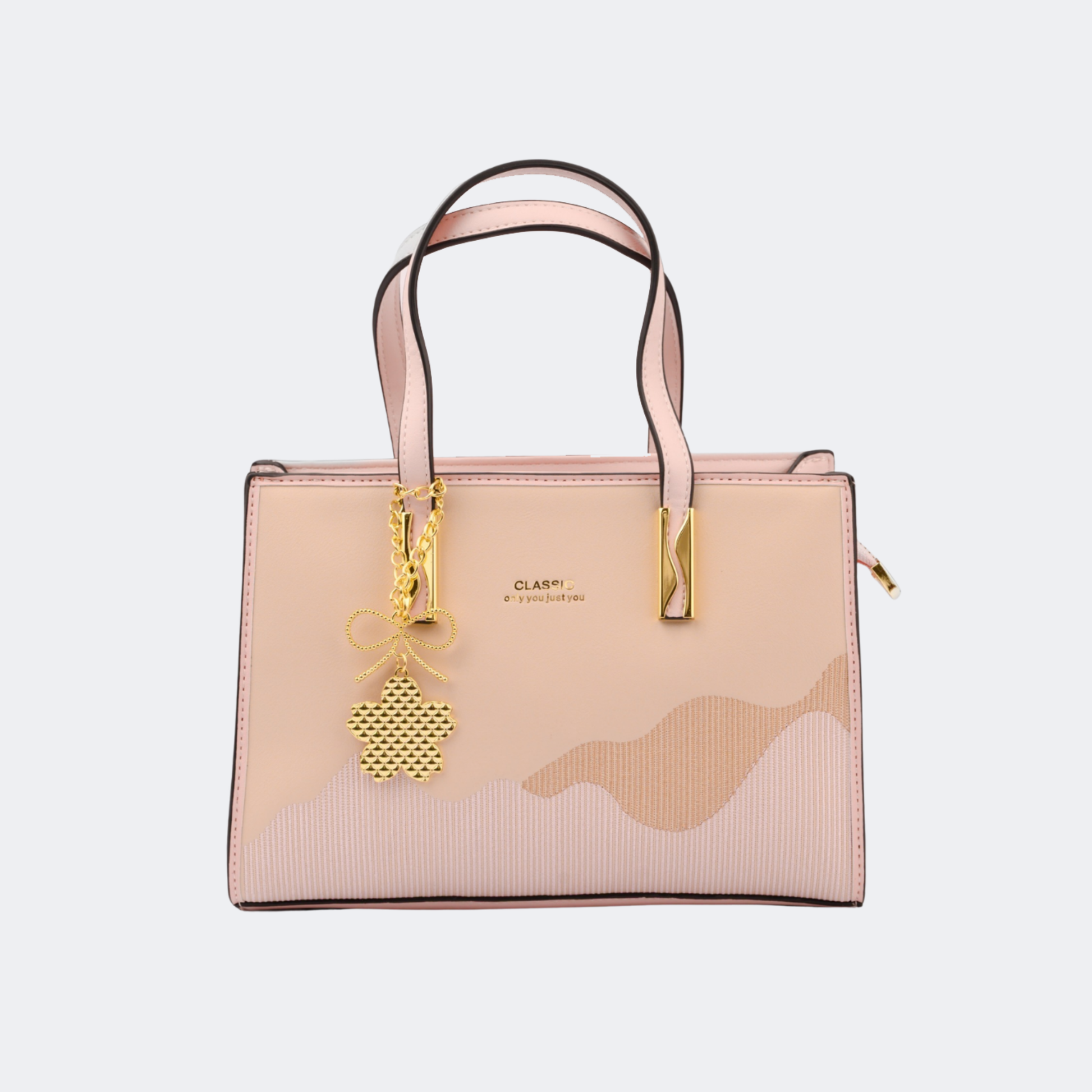 Beige handbag with gold accents on a light gray background | Vogelle