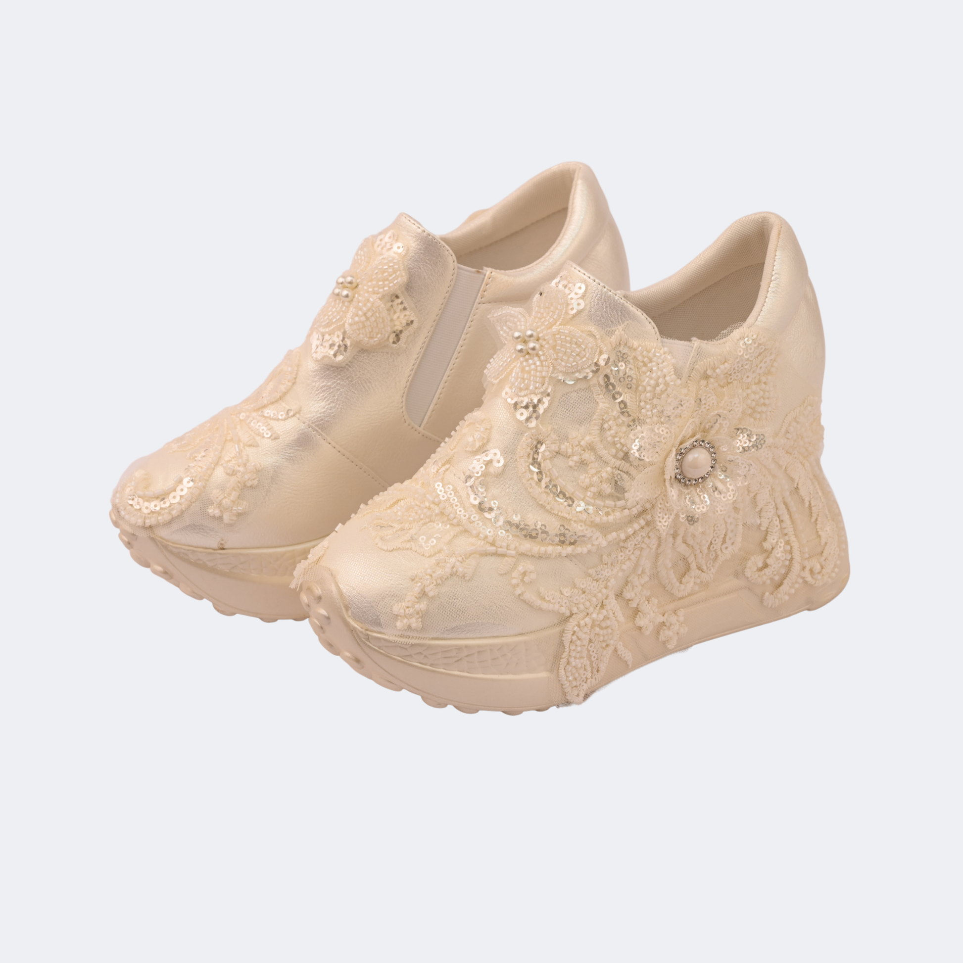 Beige lace-up shoes with decorative elements on a light gray background | Vogelle