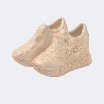 Beige lace-up shoes with decorative elements on a light gray background | Vogelle