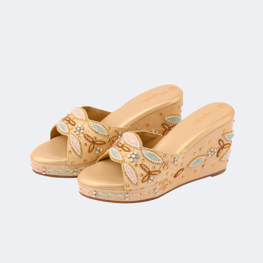 Beige wedge sandals with decorative elements on a light gray background | Vogelle