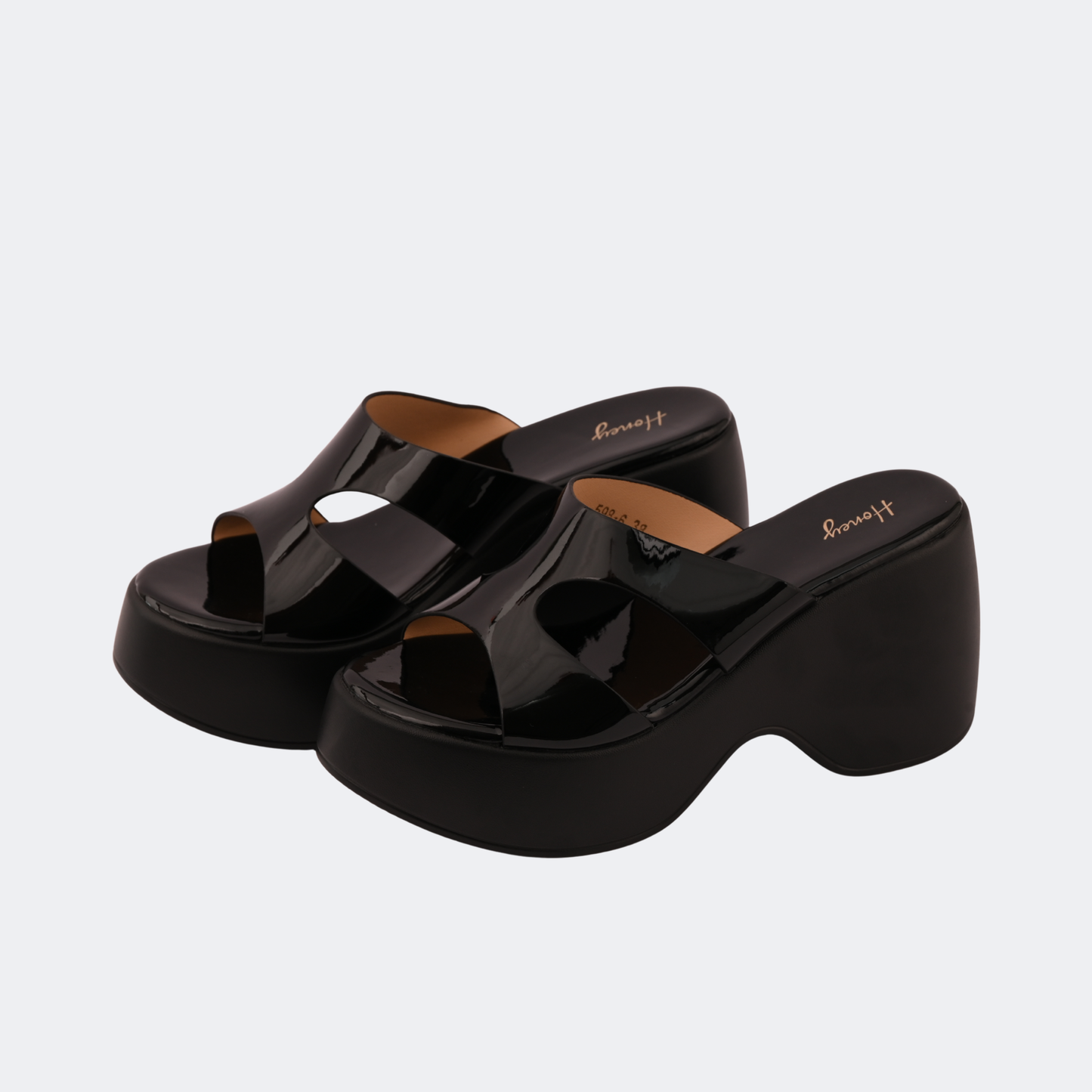Black platform sandals on a light gray background | Vogelle