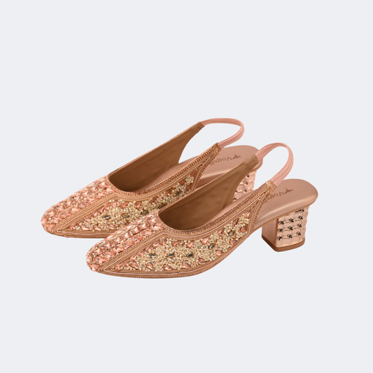 Pair of embellished pink shoes on a light gray background | Vogelle