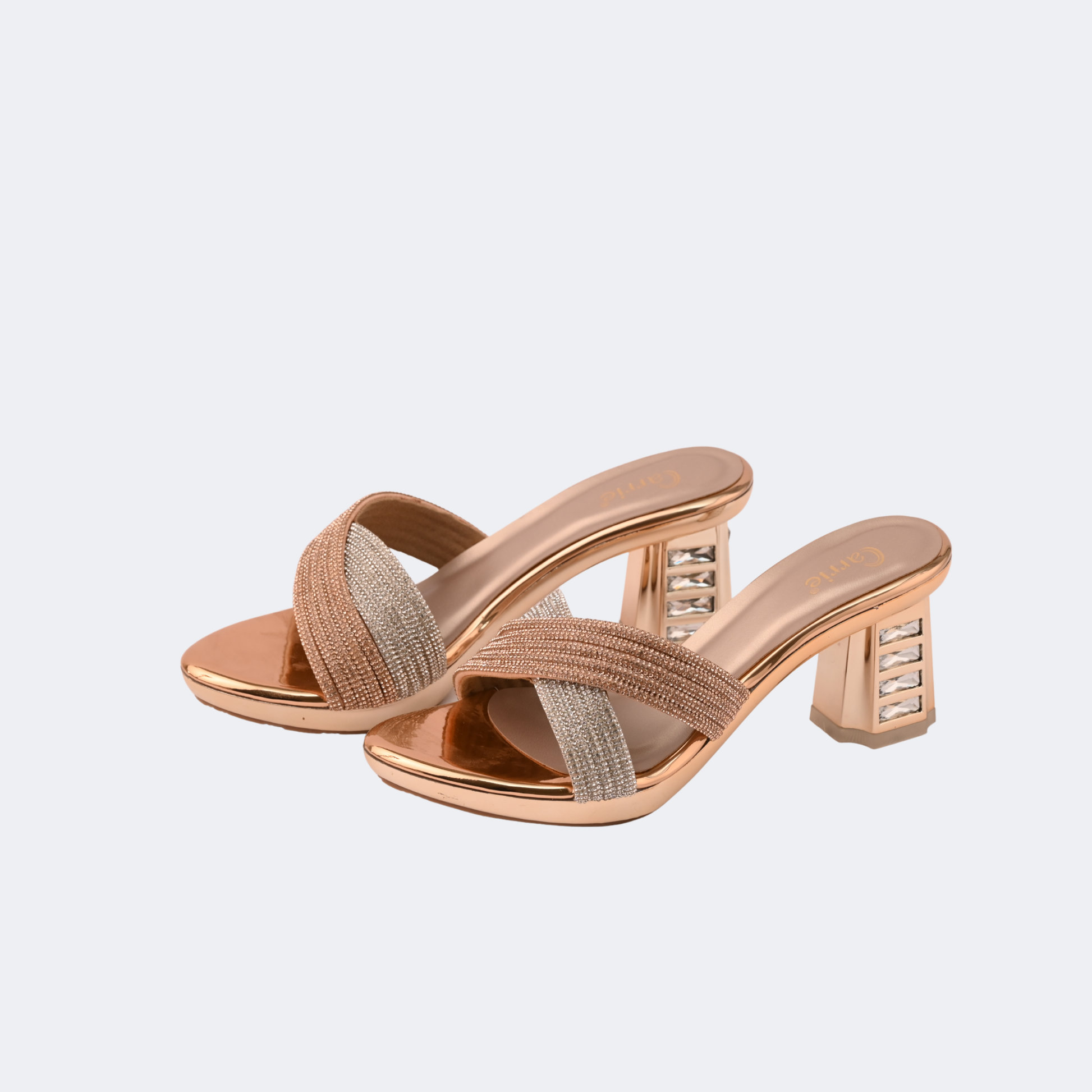 Pair of rose gold high-heeled sandals on a light gray background | Vogelle