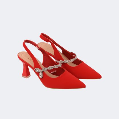 Red high-heeled shoes with a decorative strap on a light gray background | Vogelle