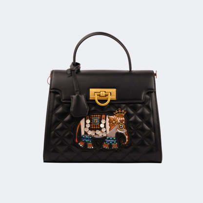 Black handbag with a decorative elephant emblem on a light gray background | Vogelle