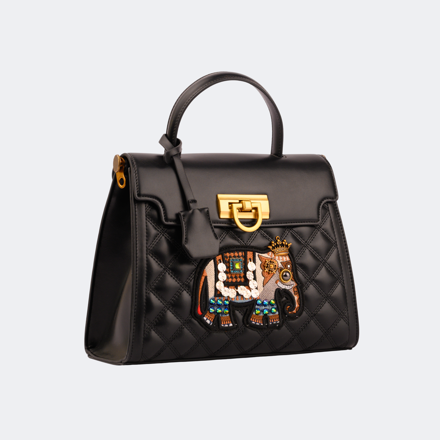 Black quilted handbag with decorative elephant emblem on a light gray background | Vogelle