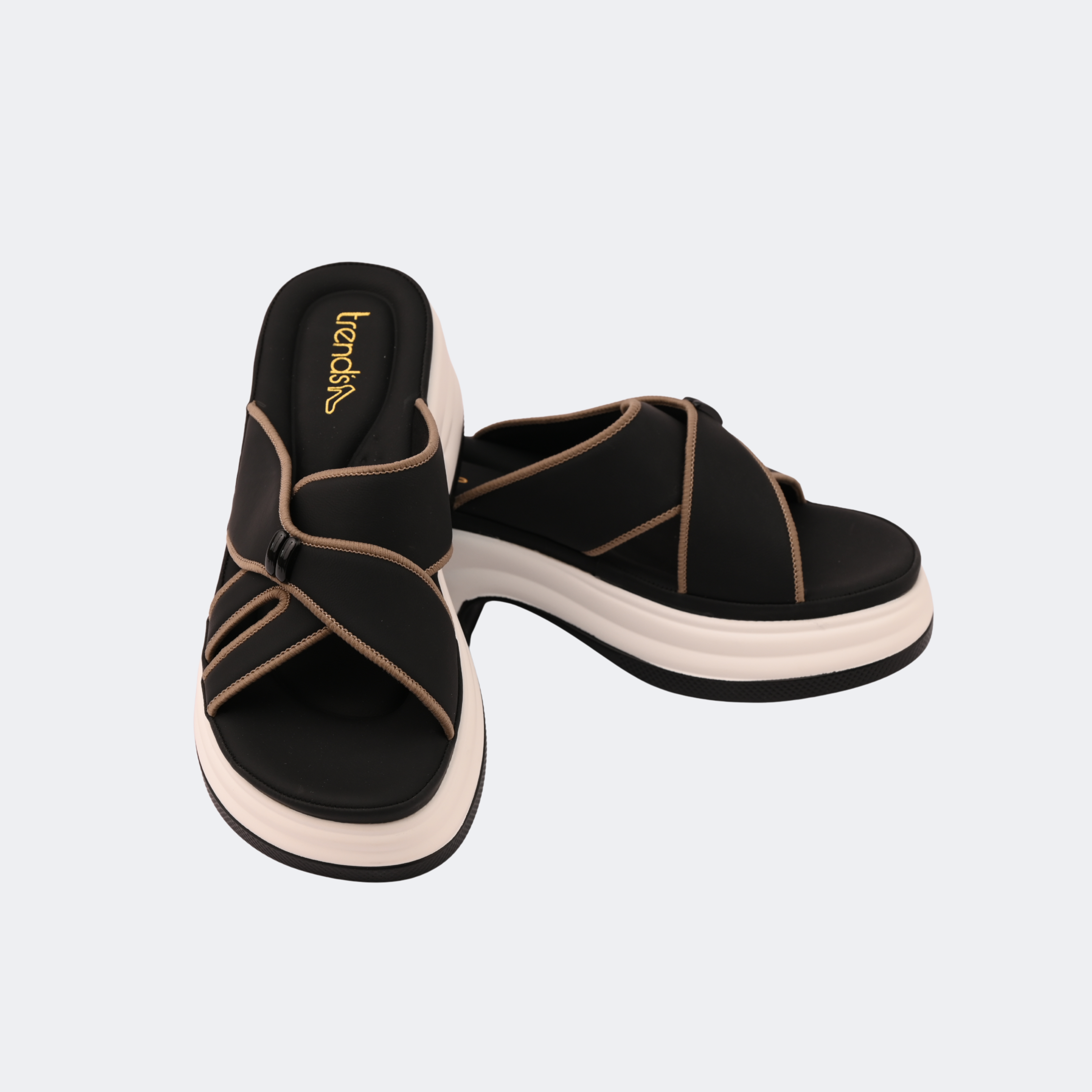 Black sandals with beige straps on a light gray background | Vogelle