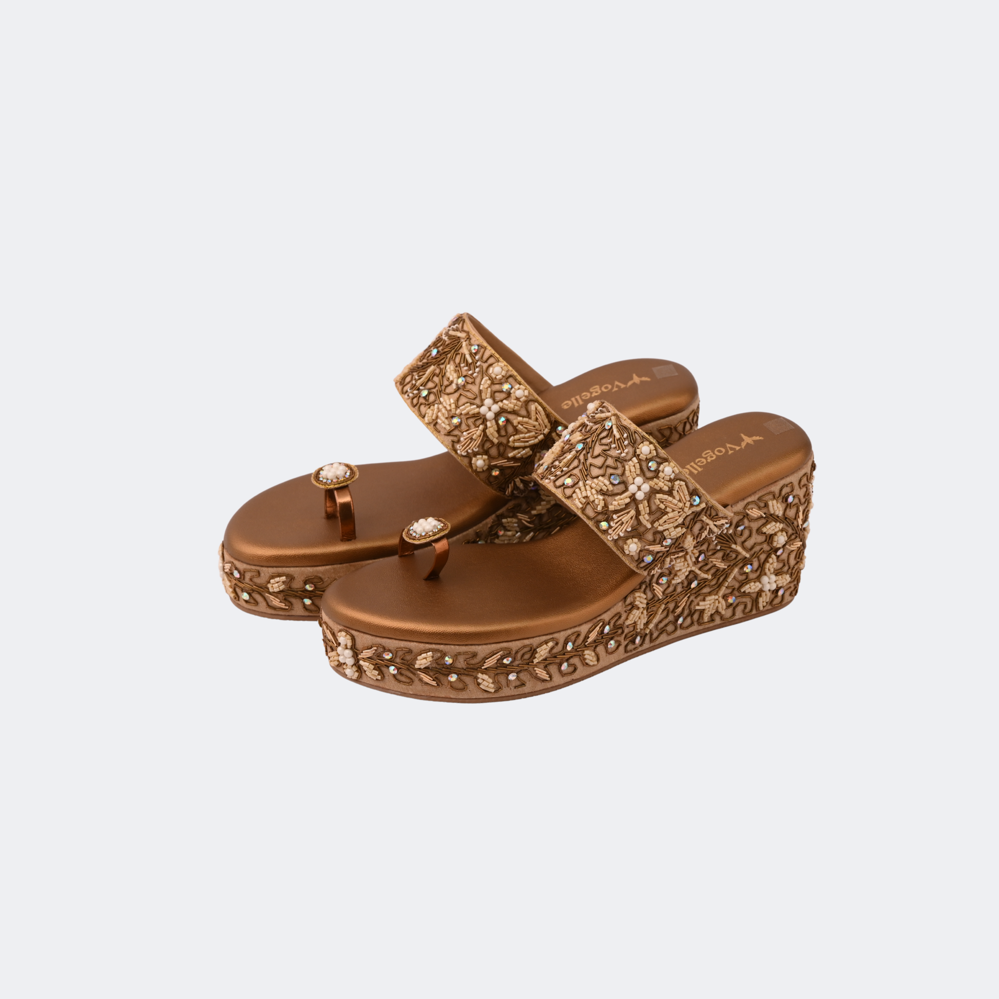 Brown embellished sandals on a light gray background | Vogelle