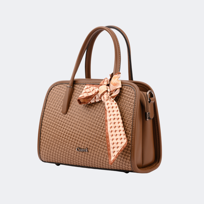 Brown handbag with a decorative bow on a light gray background | Vogelle
