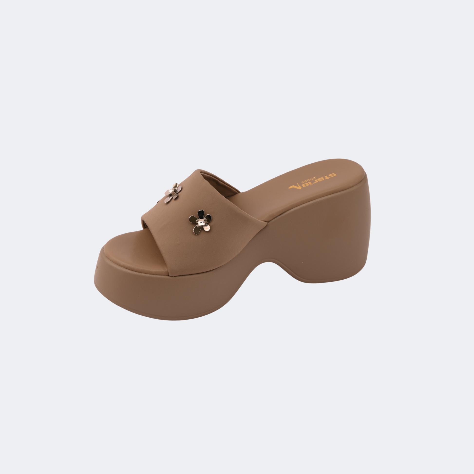 Brown platform sandal with a decorative flower on a light gray background | Vogelle
