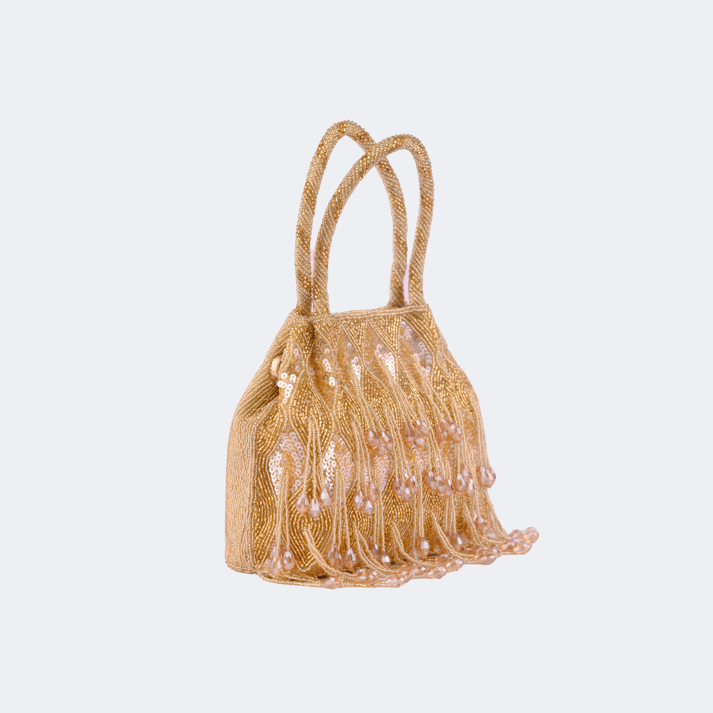 Gold beaded handbag with tassels on a light gray background | Vogelle