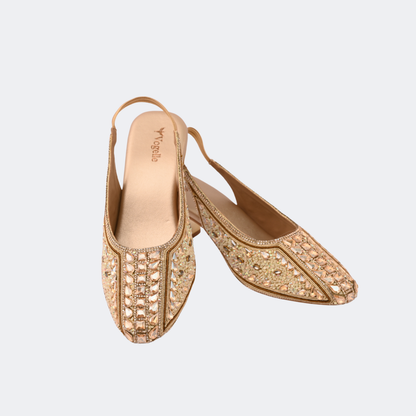 Gold embellished shoes on a light gray background | Vogelle