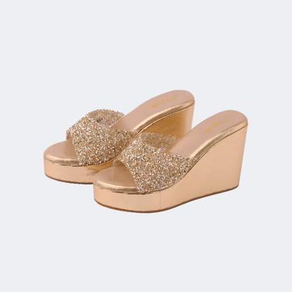 Gold glitter wedge sandals on a light gray background | vogelle