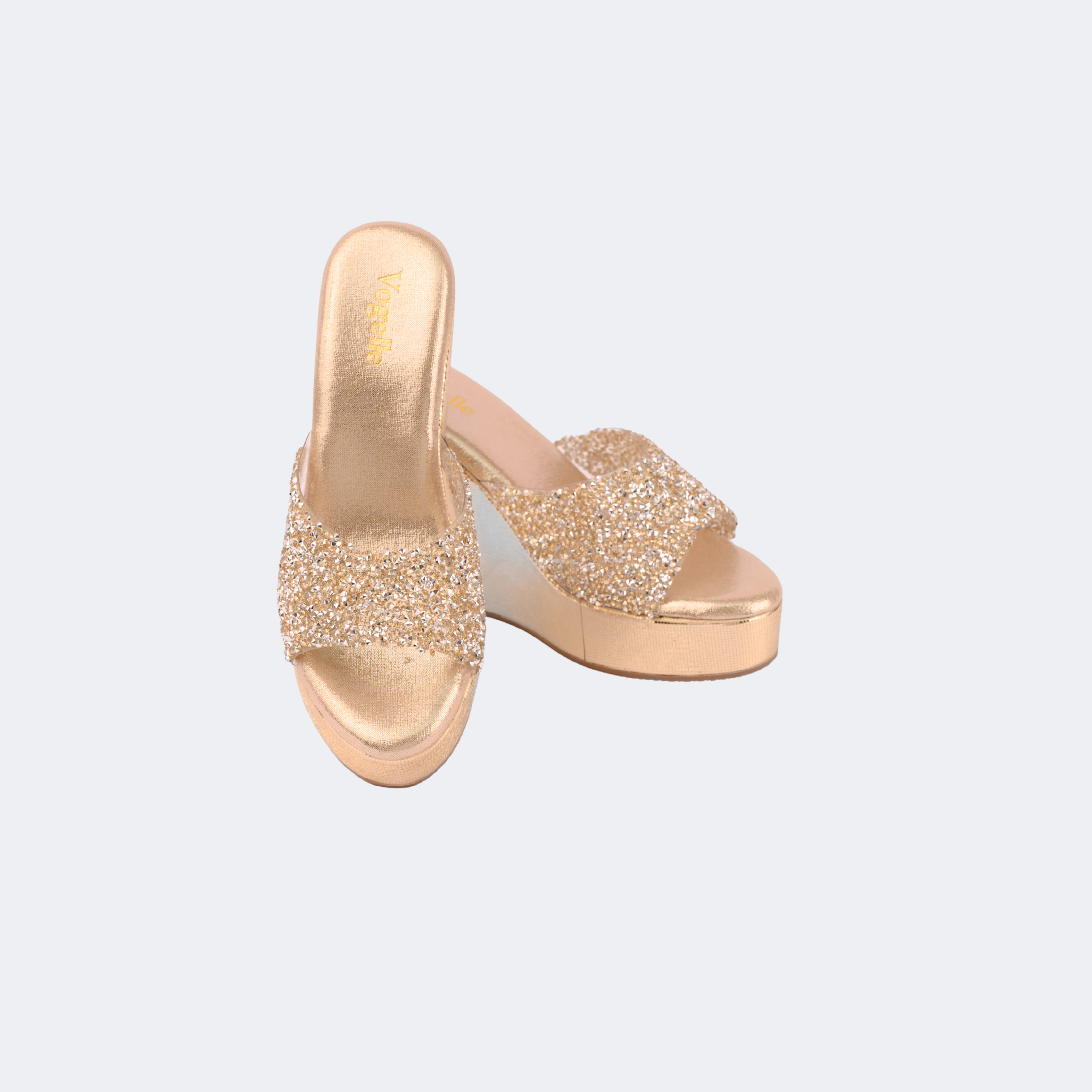 Gold glittery platform sandals on a light gray background | Vogelle