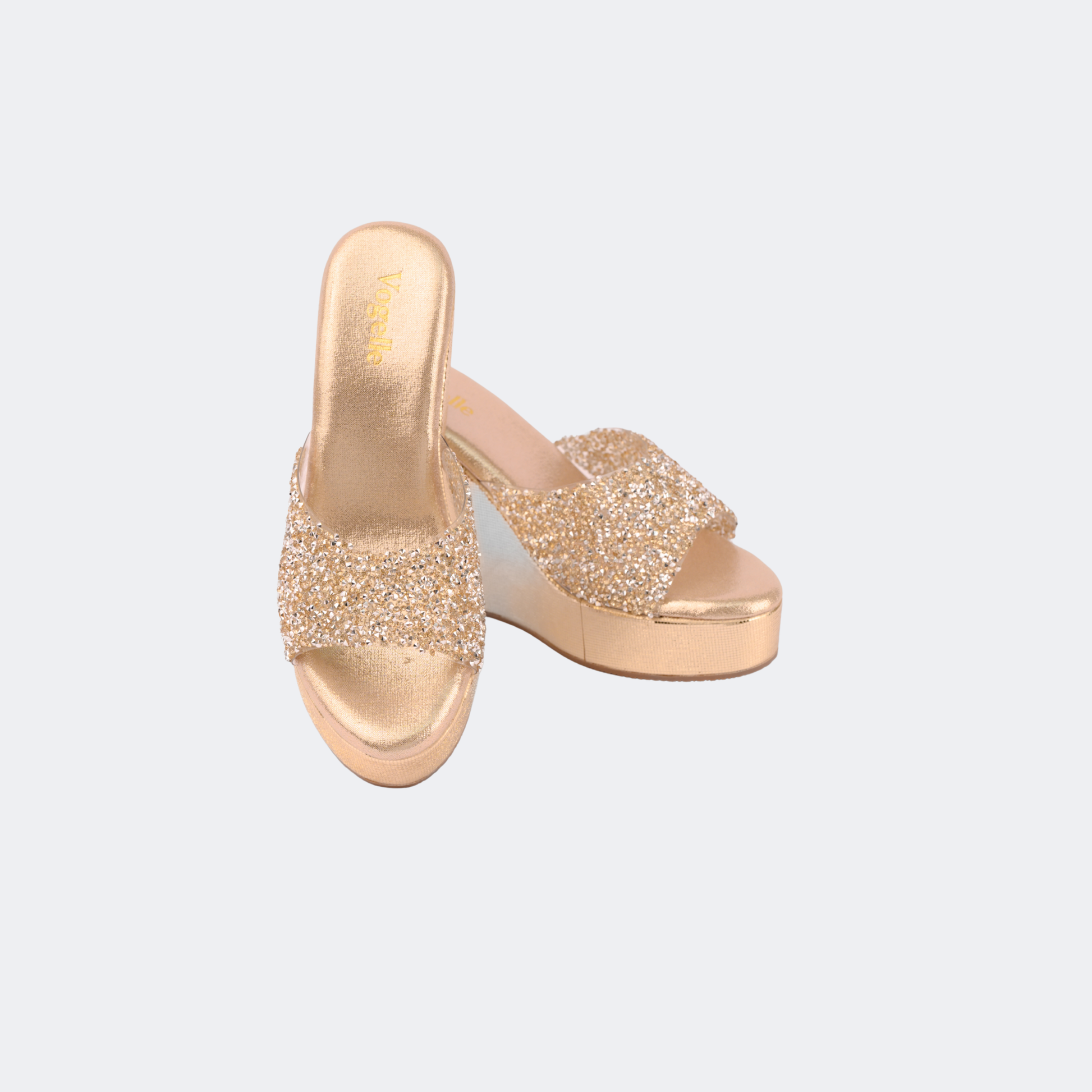 Gold glittery platform sandals on a light gray background | Vogelle