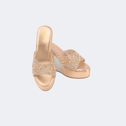 Gold glittery platform sandals on a light gray background | Vogelle