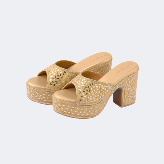 Gold platform sandals with cut-out design on a light gray background | Vogelle