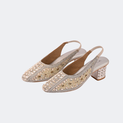 Pair of embellished high-heeled shoes on a light gray background Vogelle