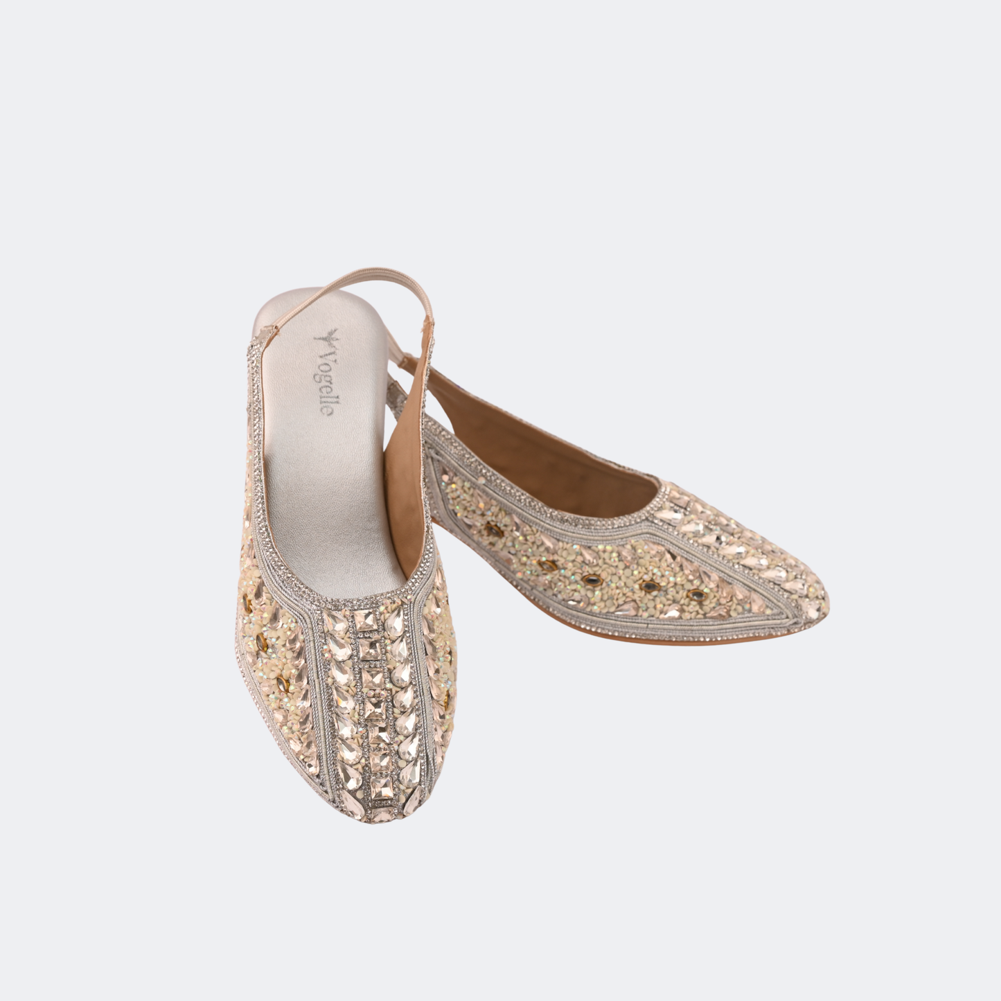 Pair of gold embroidered shoes on a light gray background | Vogelle
