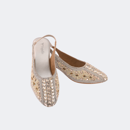 Pair of gold embroidered shoes on a light gray background | Vogelle