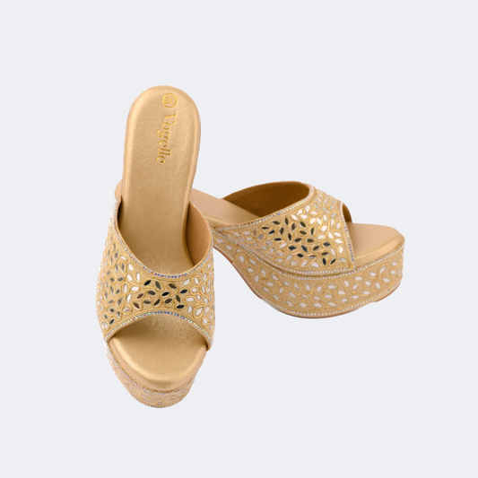 Pair of gold sandals with cut-out design on a light gray background | Vogelle