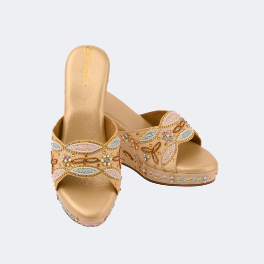Pair of gold sandals with decorative elements on a light gray background | Vogelle