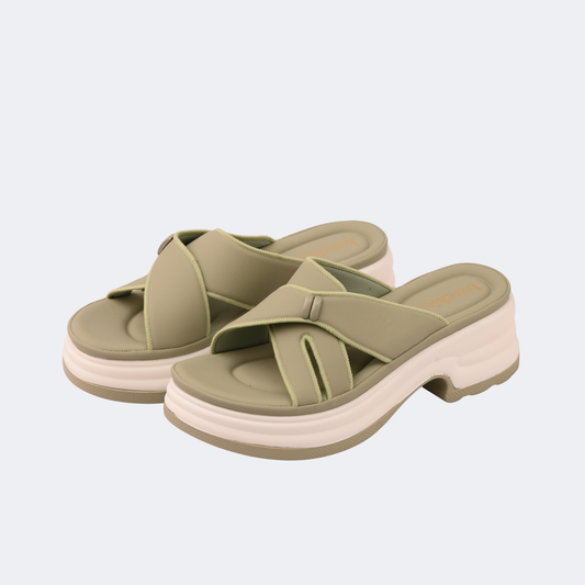 Pair of green sandals with a white sole on a light gray background  | Vogelle