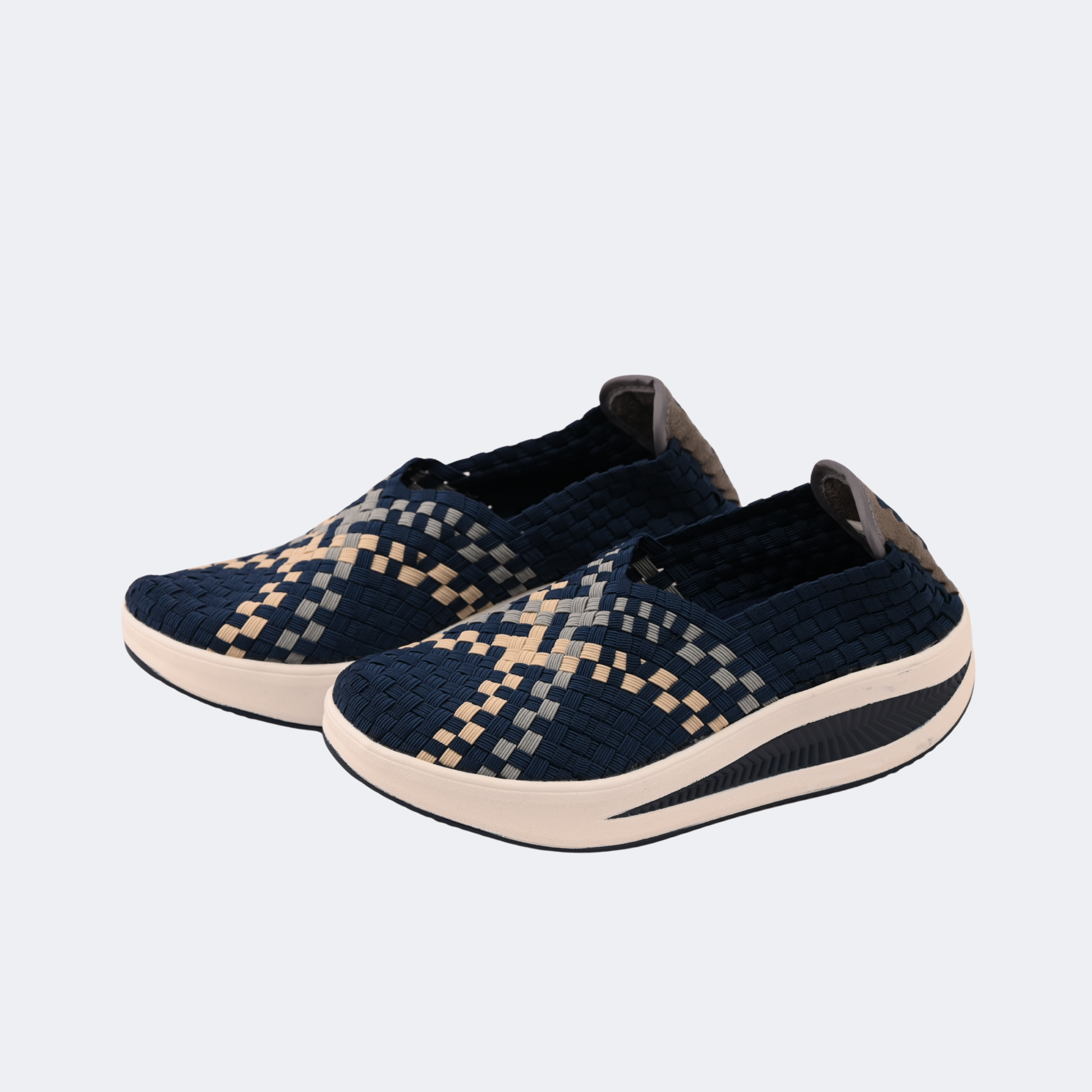 Pair of navy blue and beige patterned shoes on a light gray background | Vogelle