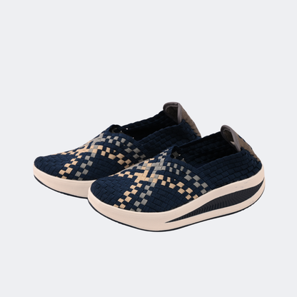 Pair of navy blue and beige patterned shoes on a light gray background | Vogelle