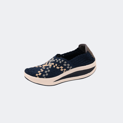 Pair of navy blue and beige patterned shoes on a light gray background | Vogelle