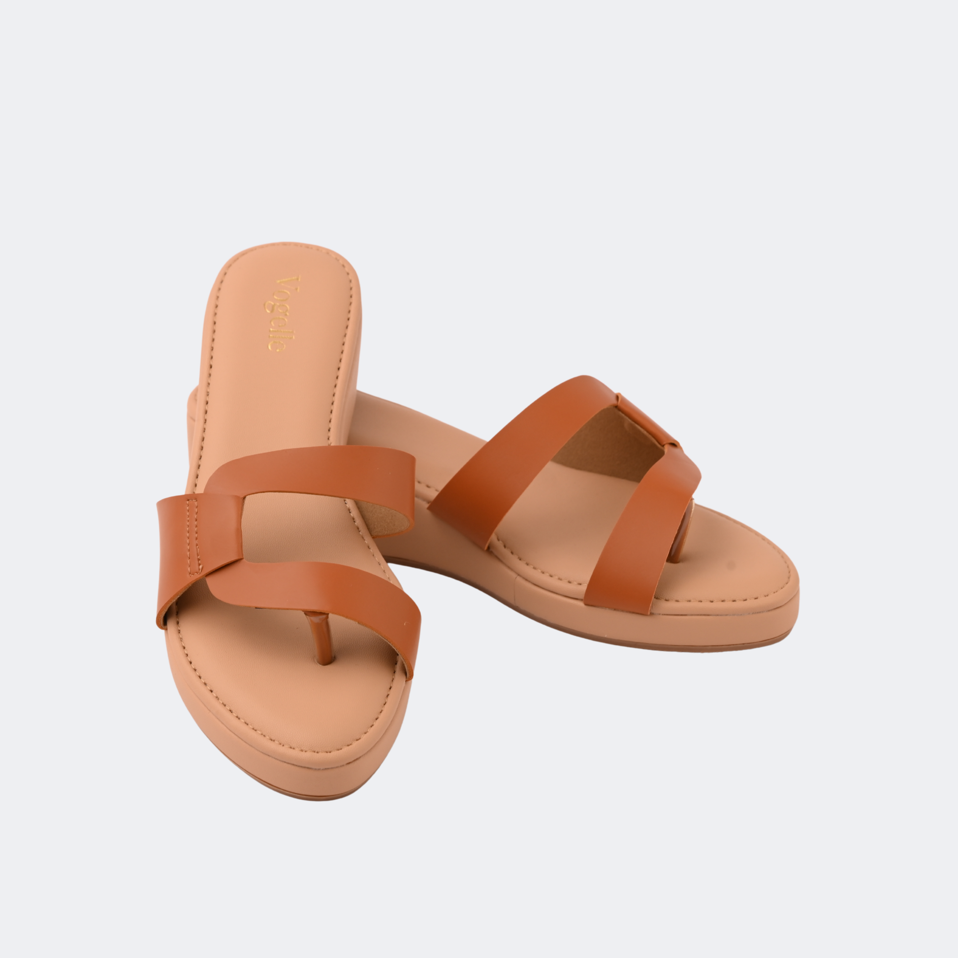 Pair of tan sandals with two straps on a light gray background | Vogelle