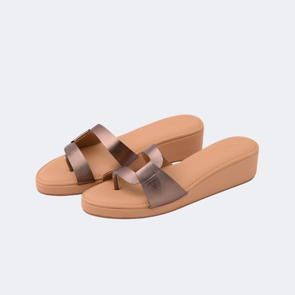 Pair of tan sandals with brown straps on a light gray background | Vogelle