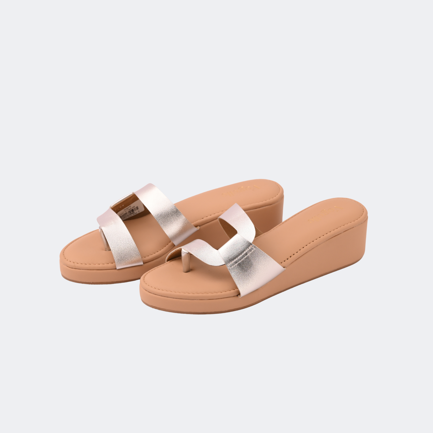 Pair of tan sandals with silver straps on a light gray background | Vogelle