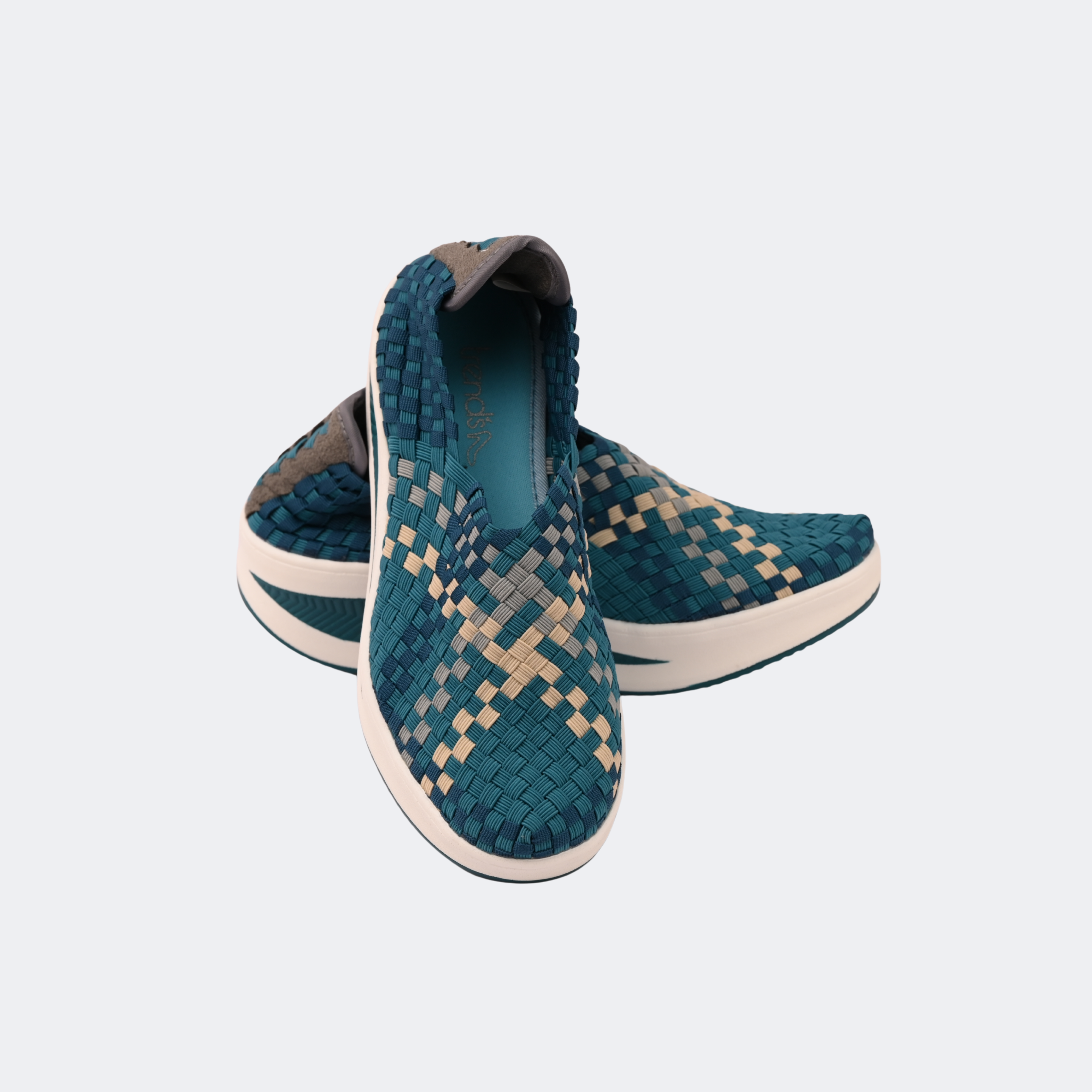 Pair of teal woven shoes on a light gray background | Vogelle
