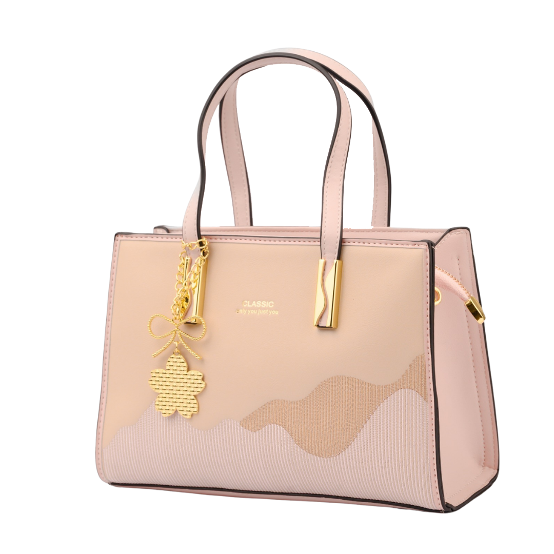 Pink handbag with gold charm on a white background | Vogelle