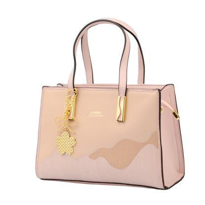 Pink handbag with gold charm on a white background | Vogelle