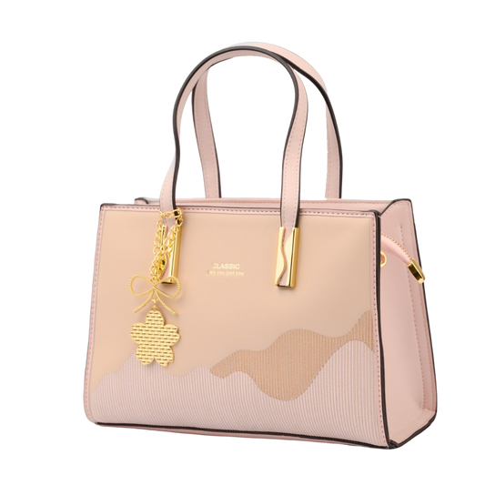 Pink handbag with gold charm on a white background | Vogelle