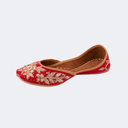 Red embroidered shoe on a white background