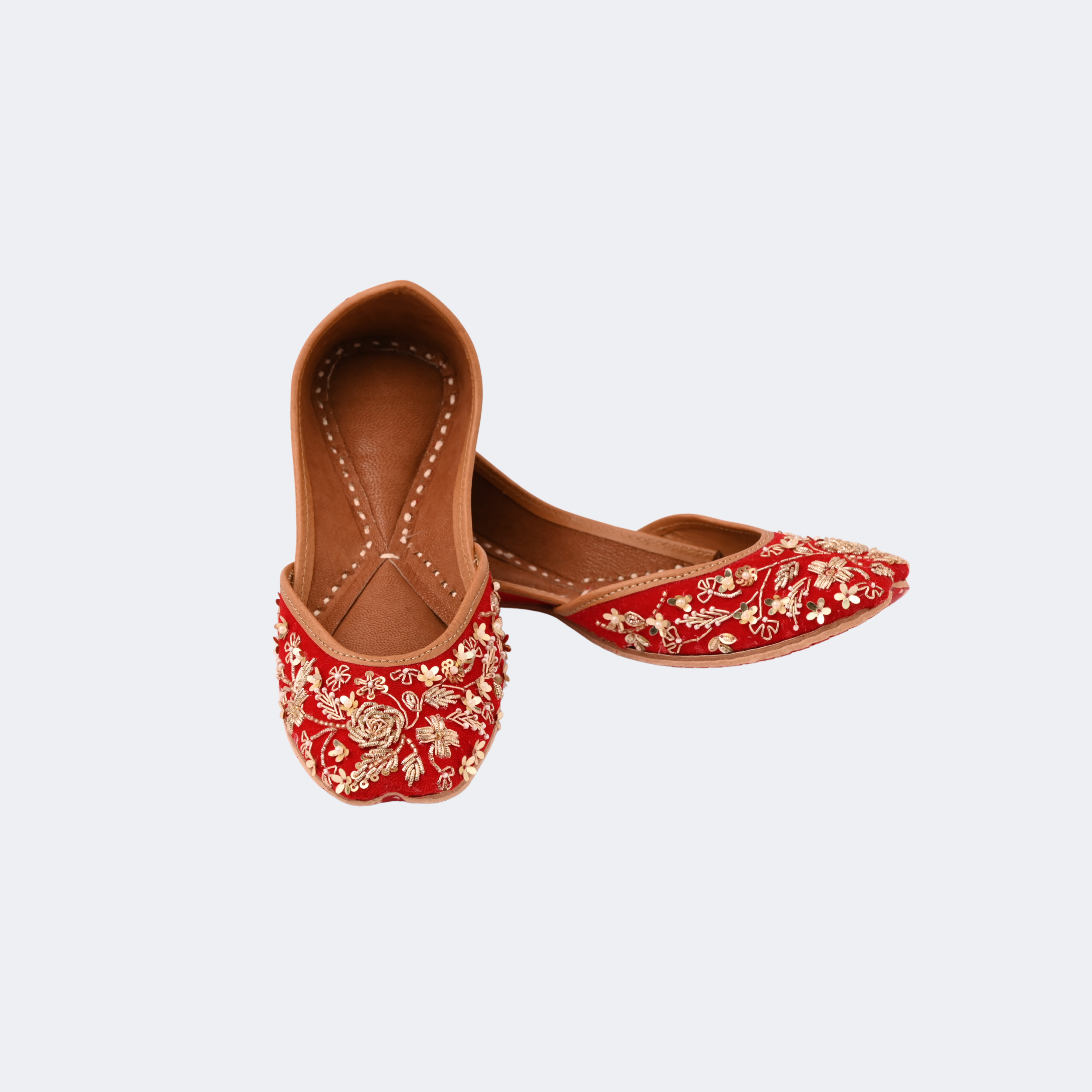 Red embroidered shoes with floral patterns on a light gray background | Vogelle