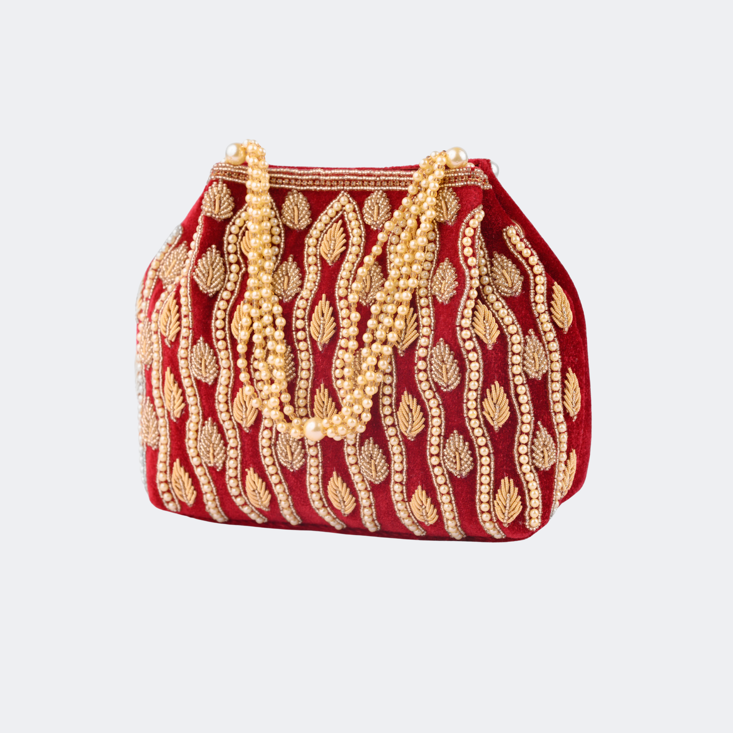 Red handbag with gold embroidery and pearl strands on a light gray background | Vogelle