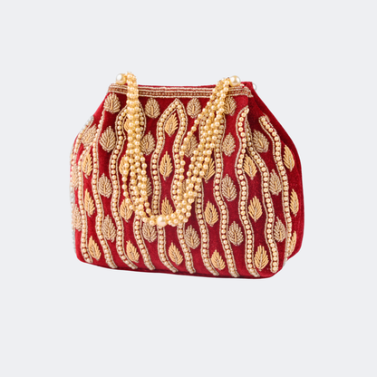 Red handbag with gold embroidery and pearl strands on a light gray background | Vogelle
