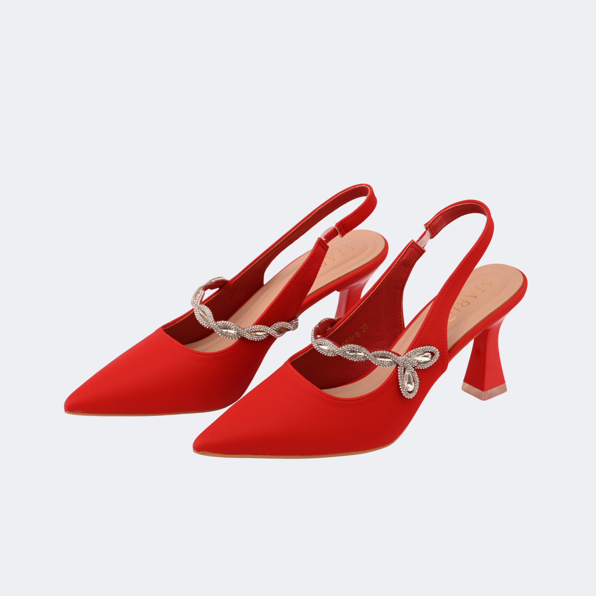 Red high-heeled shoes with a decorative strap on a light gray background | Vogelle
