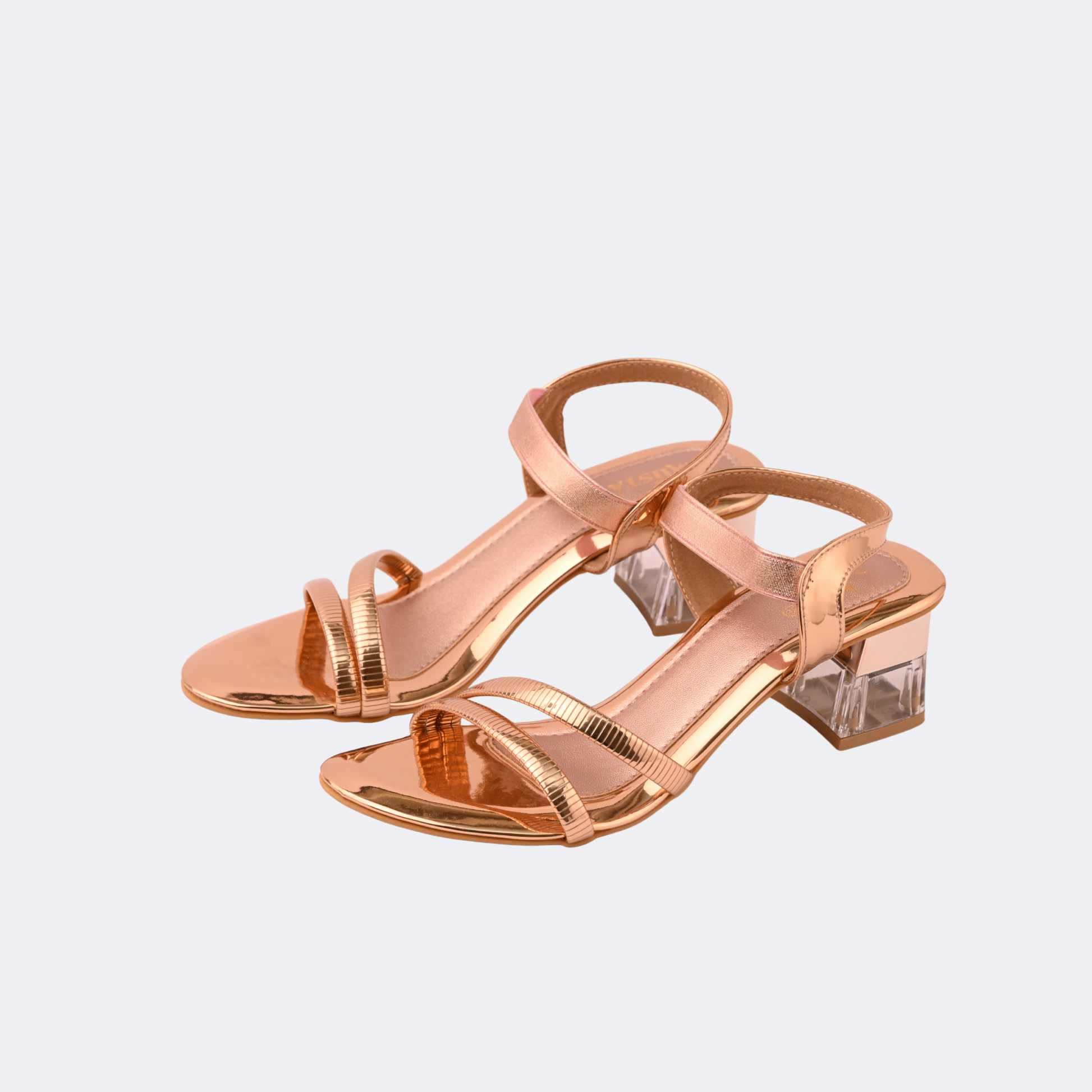 Rose gold high-heeled sandals with clear transparent heel on a light gray background | Vogelle