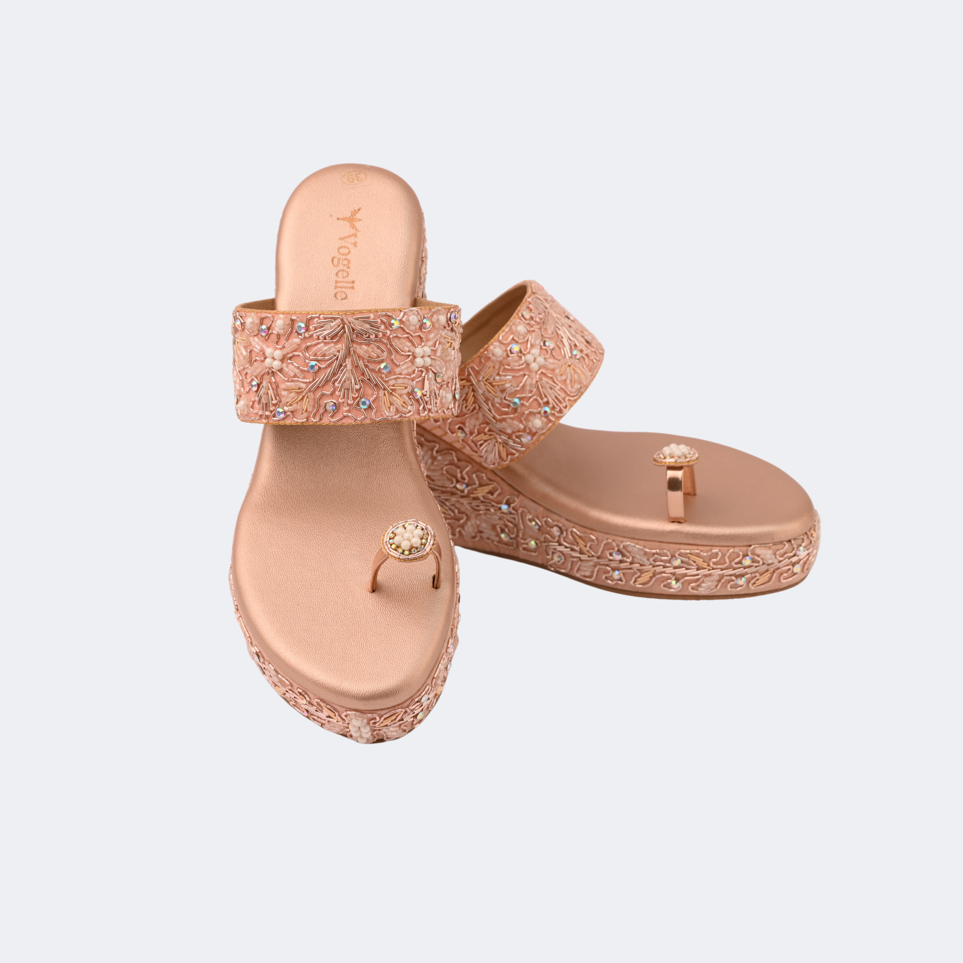 Rose gold sandals with embellishments on a light gray background | Vogelle